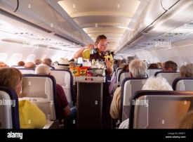 C:\Users\1\Desktop\a-flight-attendant-member-of-the-cabin-crew-serving-food-on-a-monarch-EP0ET1.jpg